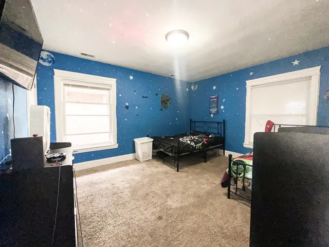 a bedroom with furniture and a window