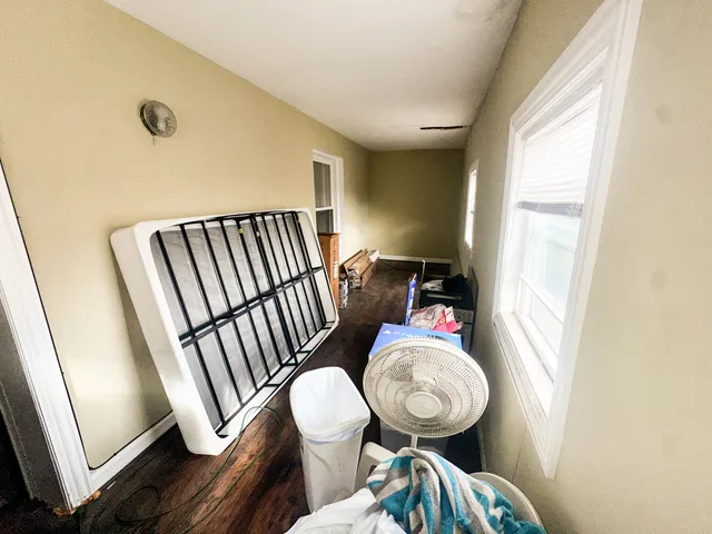 a view of bathroom with a toilet mirror and a window