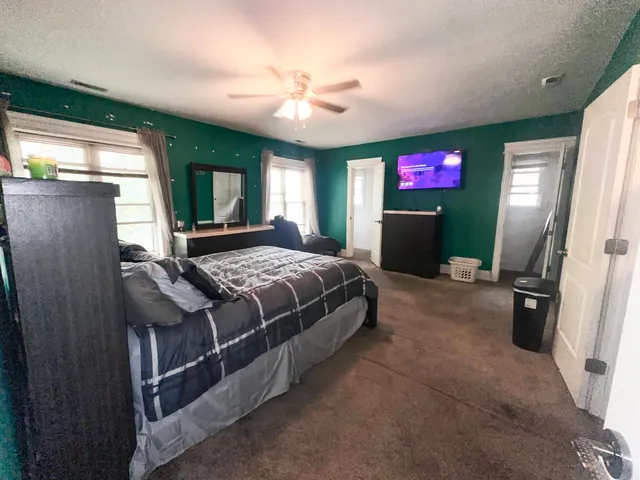 a bedroom with a bed and a flat screen tv