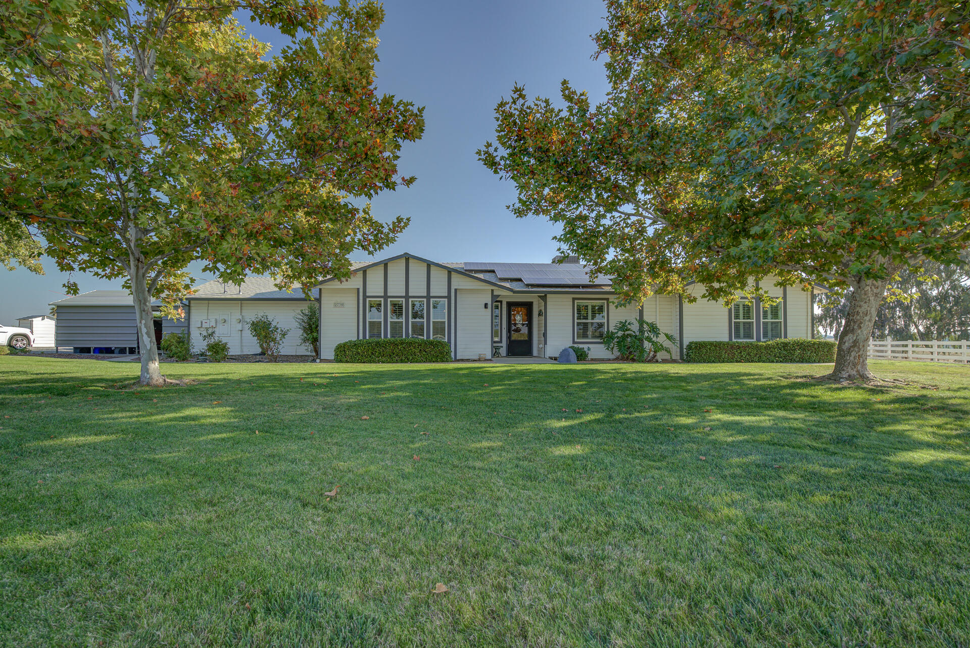 2730 Hall Road Corning, CA 96021 - Photo 2 of 52 a front view of a house with a garden