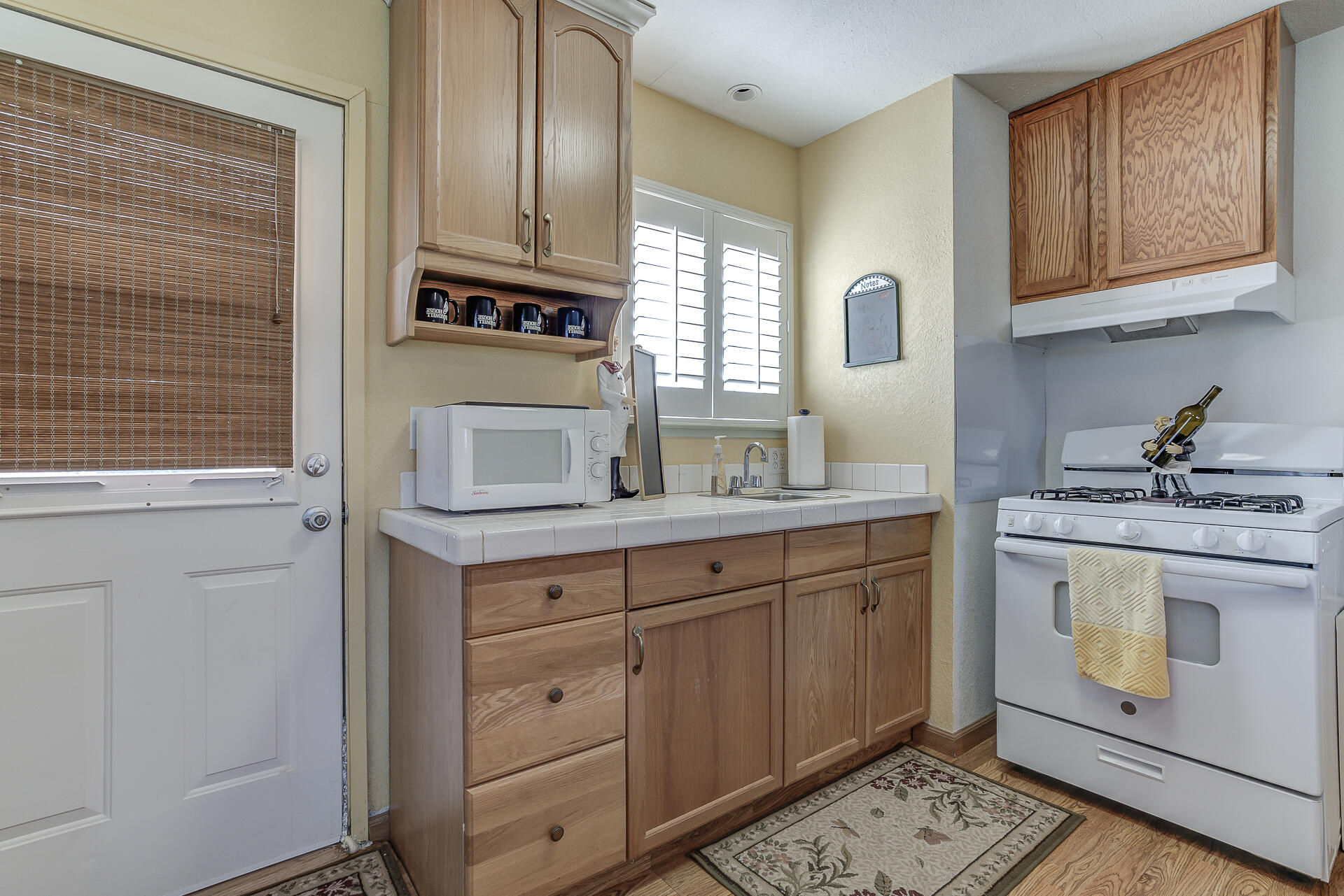 2730 Hall Road Corning, CA 96021 - Photo 29 of 52 a kitchen with granite countertop cabinets stainless steel appliances and a sink