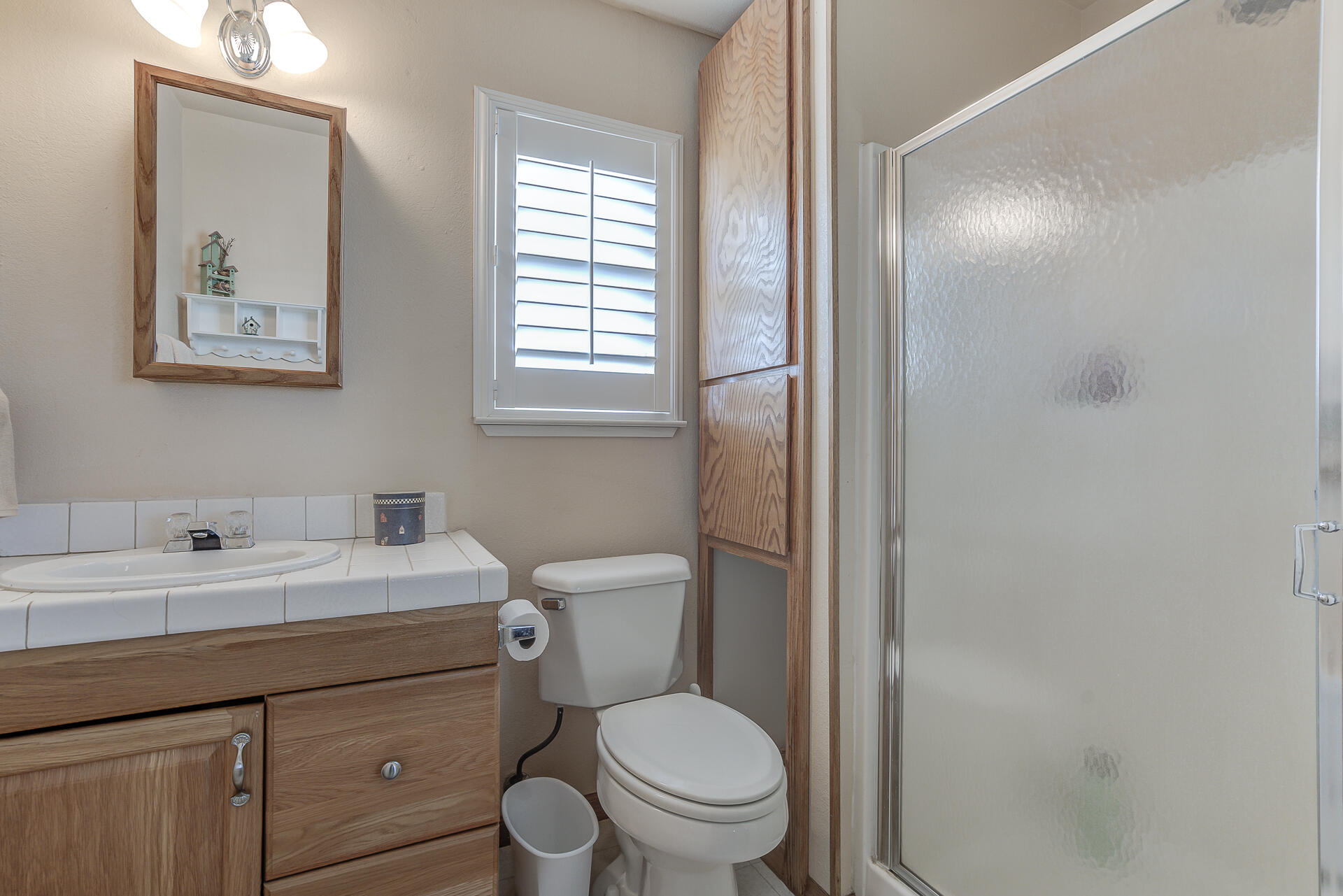 2730 Hall Road Corning, CA 96021 - Photo 31 of 52 a bathroom with a toilet a sink and mirror