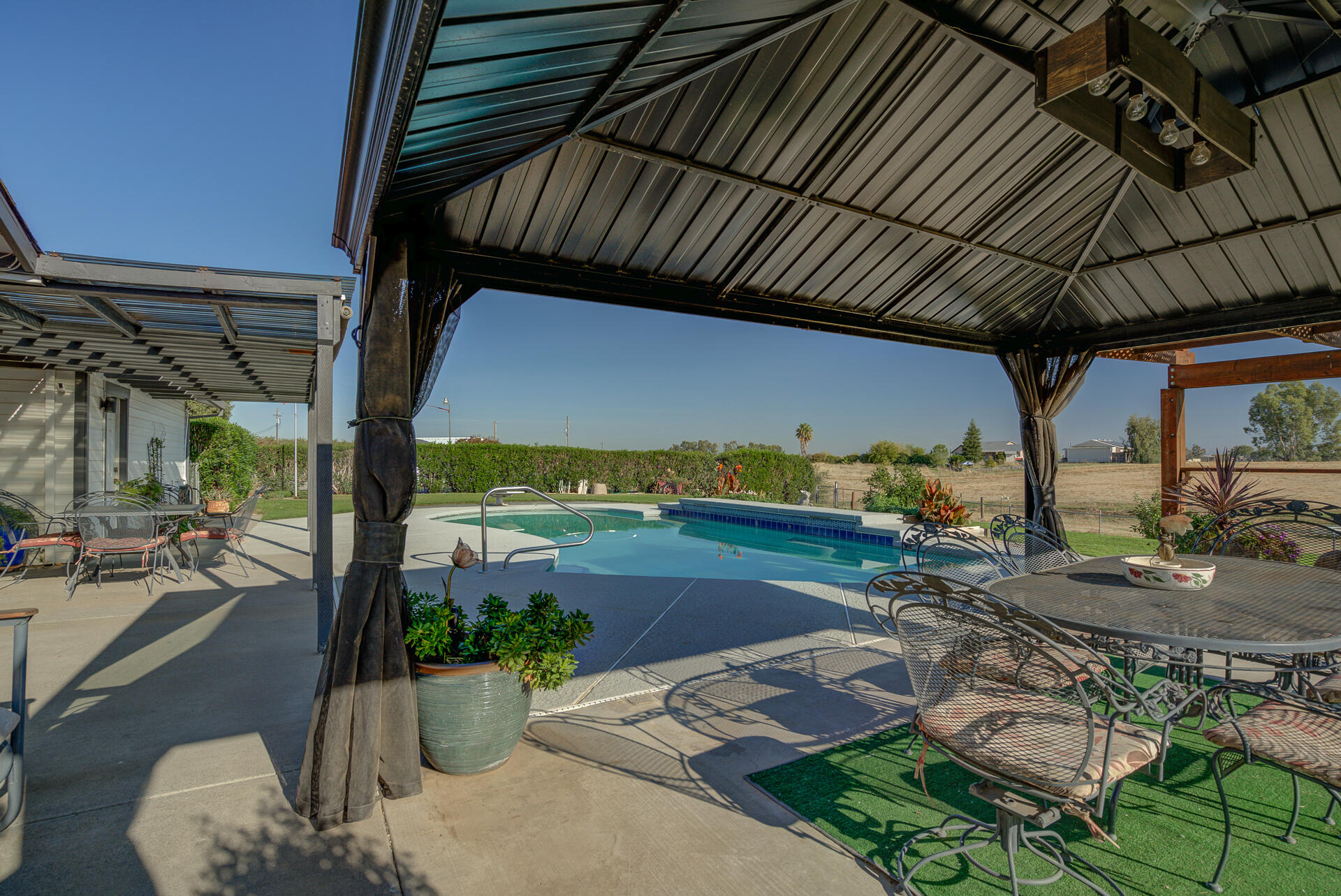2730 Hall Road Corning, CA 96021 - Photo 36 of 52 a view of a patio with table and chairs potted plants