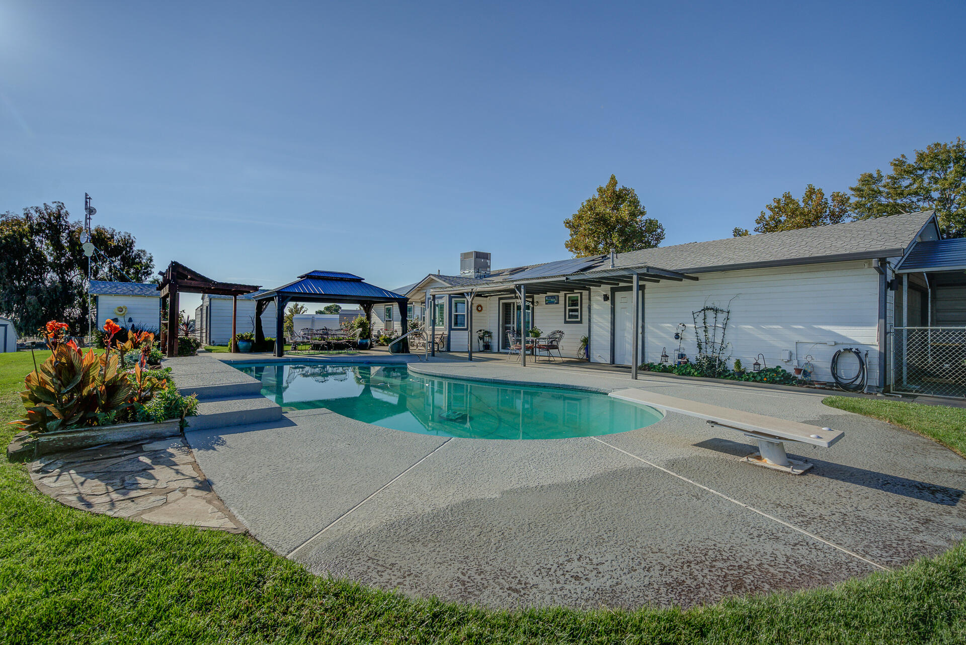 2730 Hall Road Corning, CA 96021 - Photo 38 of 52 a front view of a house with a garden and patio