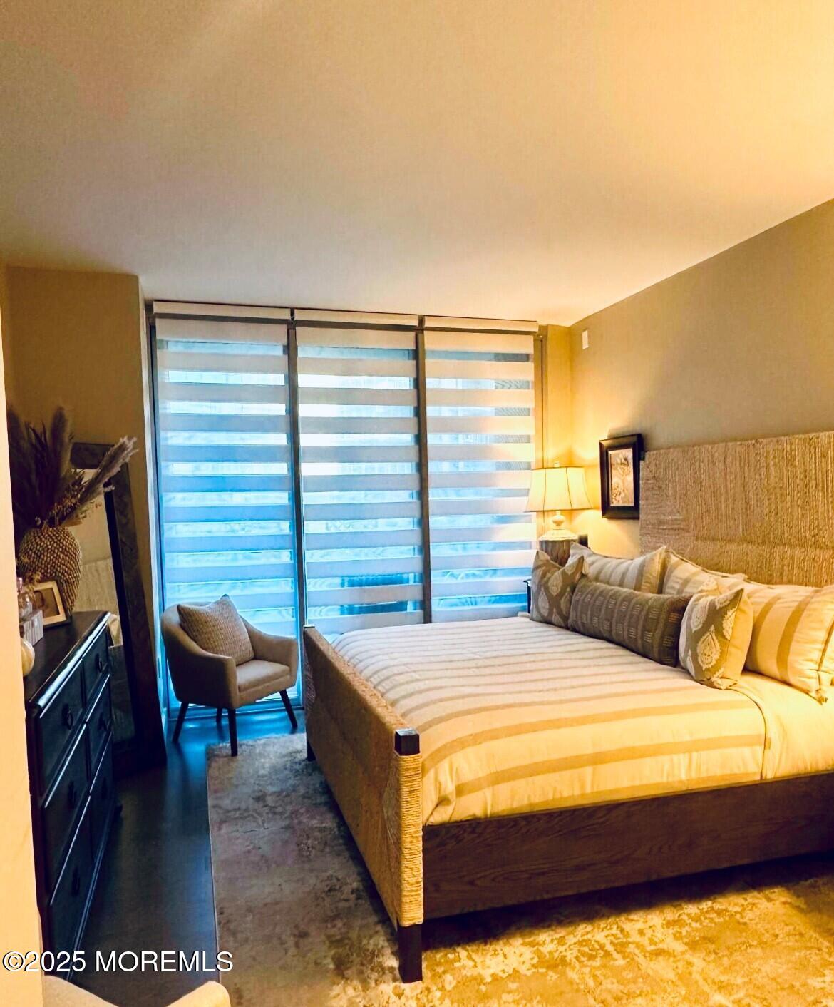 15 Morris Avenue, Unit 204 Long Branch, NJ 07740 - Photo 11 of 26 a bedroom with a bed and a chair