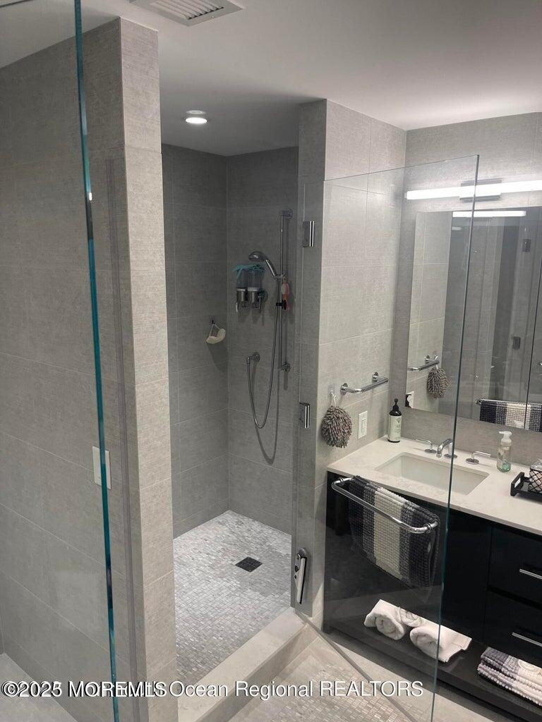 15 Morris Avenue, Unit 204 Long Branch, NJ 07740 - Photo 13 of 26 a bathroom with a sink a toilet and shower