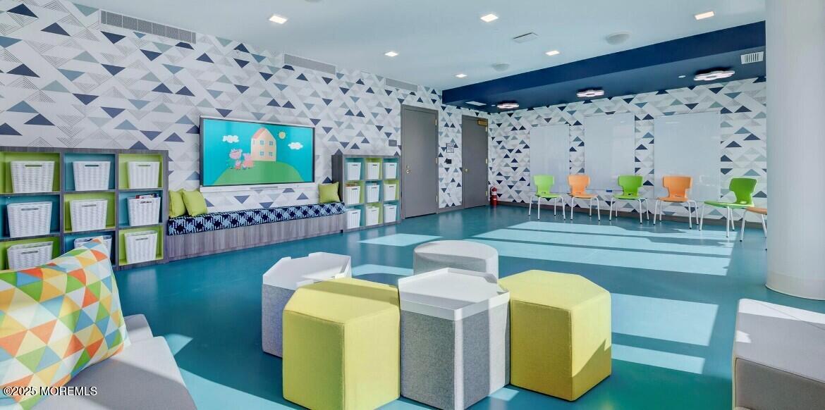 15 Morris Avenue, Unit 204 Long Branch, NJ 07740 - Photo 16 of 26 a living room with furniture and a flat screen tv