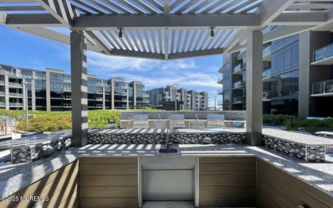 15 Morris Avenue, Unit 204 Long Branch, NJ 07740 - Photo 19 of 26 a outdoor view of a building with swimming pool