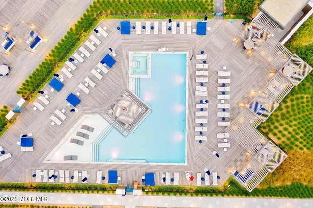 a view of swimming pool with outdoor seating and a garden