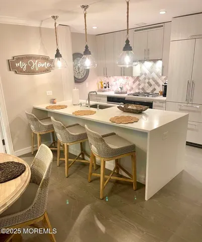 a view of dining room and cabinets with wooden floor