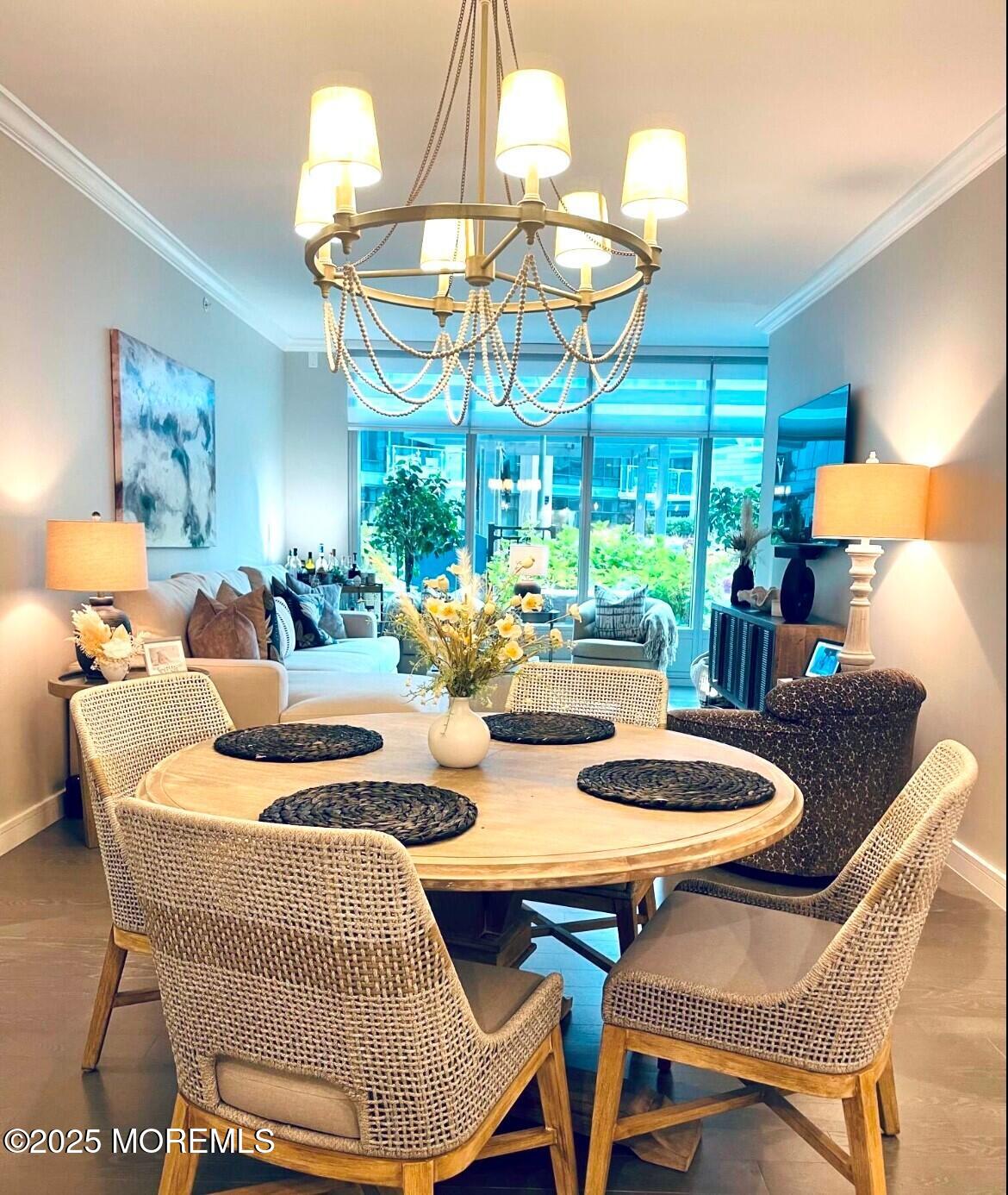 15 Morris Avenue, Unit 204 Long Branch, NJ 07740 - Photo 9 of 26 a dining room with furniture a chandelier a large window and a rug