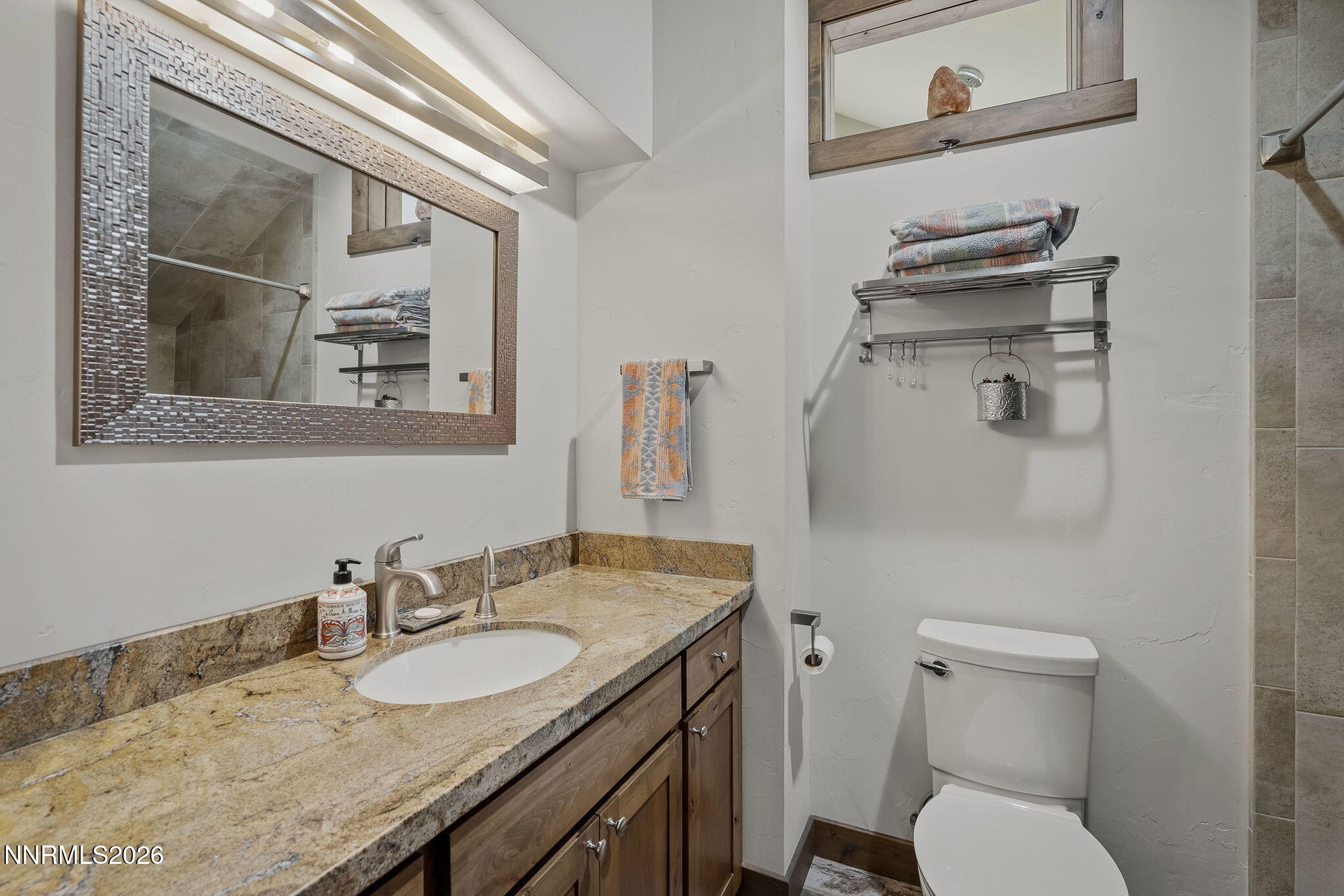 396 Tramway Drive Stateline, NV 89449 - Photo 15 of 19 a bathroom with a granite countertop toilet sink and mirror
