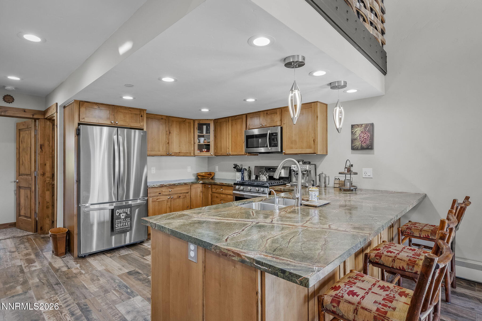396 Tramway Drive Stateline, NV 89449 - Photo 4 of 19 a kitchen with stainless steel appliances granite countertop a sink refrigerator and cabinets
