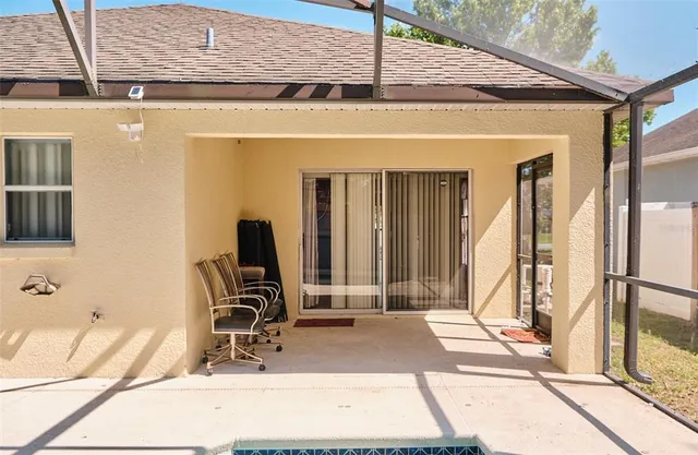 a view of a patio with a table and chairs