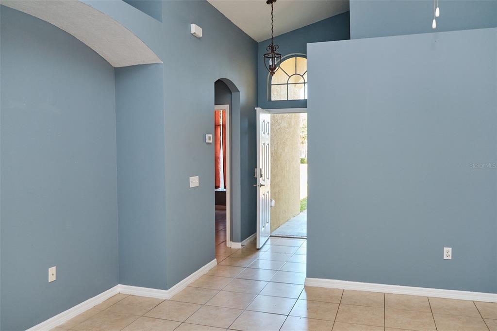 2726 Randal Way Kissimmee, FL 34743 - Photo 7 of 20 a view of entryway with window and wooden floor
