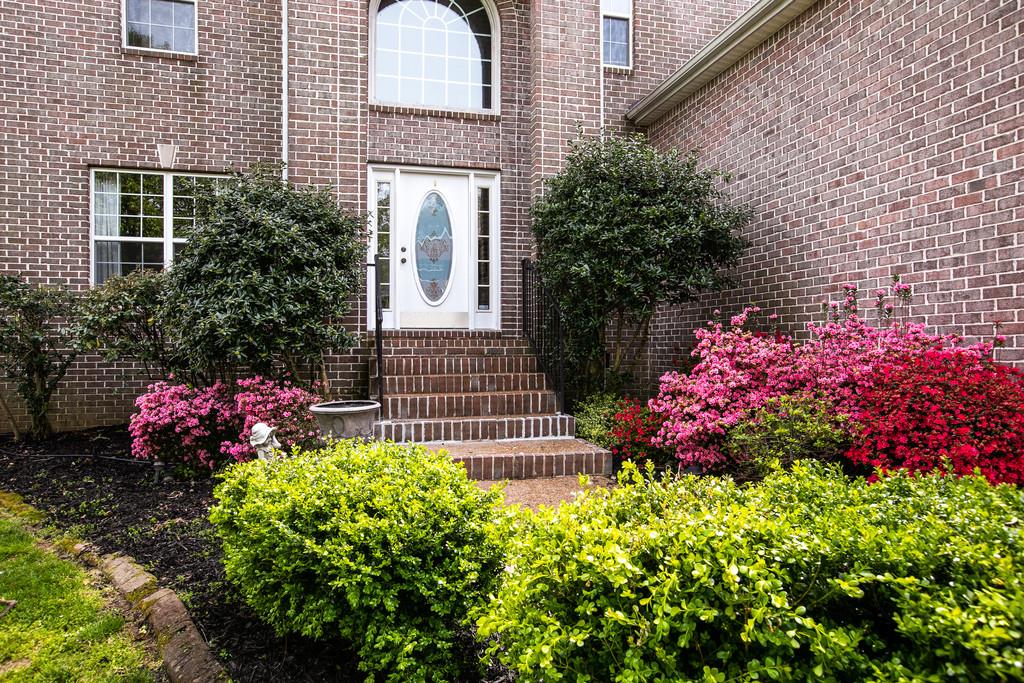 1609 Inverness Drive Spring Hill, TN 37174 - Photo 3 of 30 A welcoming entry to the home which is lined with mature flowering shrubs.