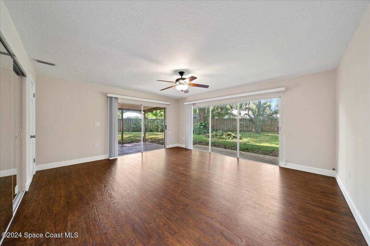 1469 Rockledge Drive Rockledge, FL 32955 - Photo 17 of 67 a view of an empty room with wooden floor and a window