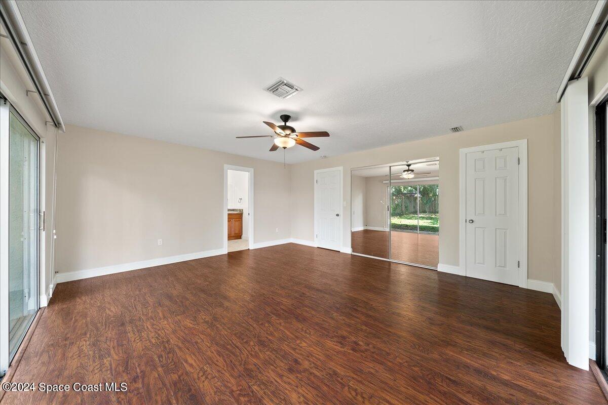 1469 Rockledge Drive Rockledge, FL 32955 - Photo 18 of 67 a view of empty room with wooden floor and fan