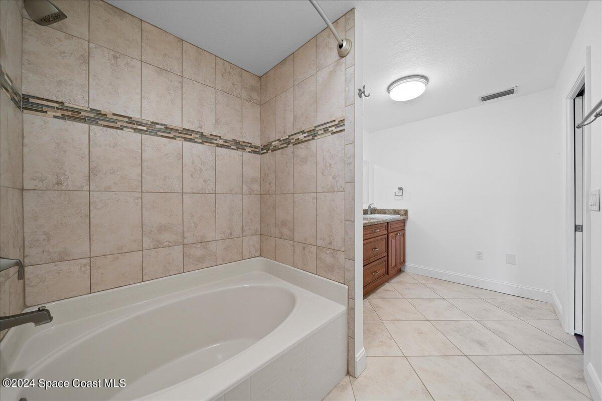 1469 Rockledge Drive Rockledge, FL 32955 - Photo 20 of 67 a bathroom with a bathtub and a shower