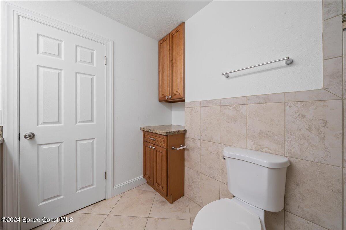 1469 Rockledge Drive Rockledge, FL 32955 - Photo 22 of 67 a white toilet sitting next to a bathroom sink