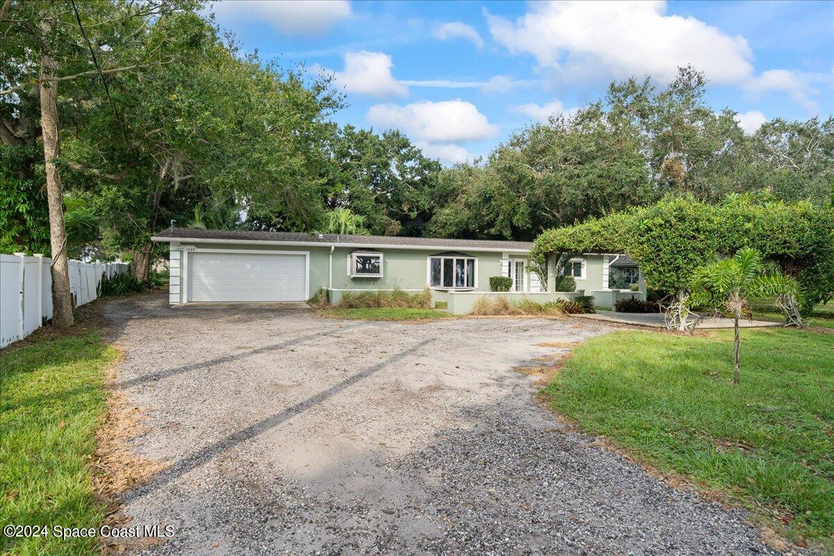 1469 Rockledge Drive Rockledge, FL 32955 - Photo 25 of 67 a front view of house with yard and green space