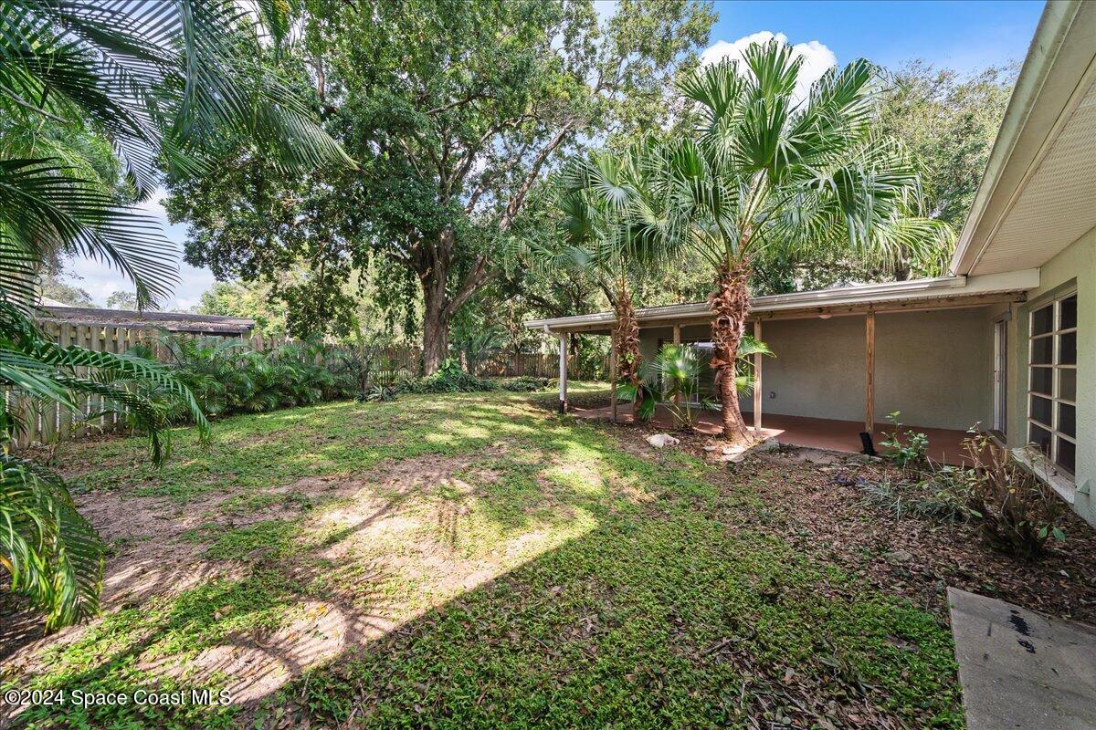 1469 Rockledge Drive Rockledge, FL 32955 - Photo 29 of 67 a backyard of a house with lots of green space