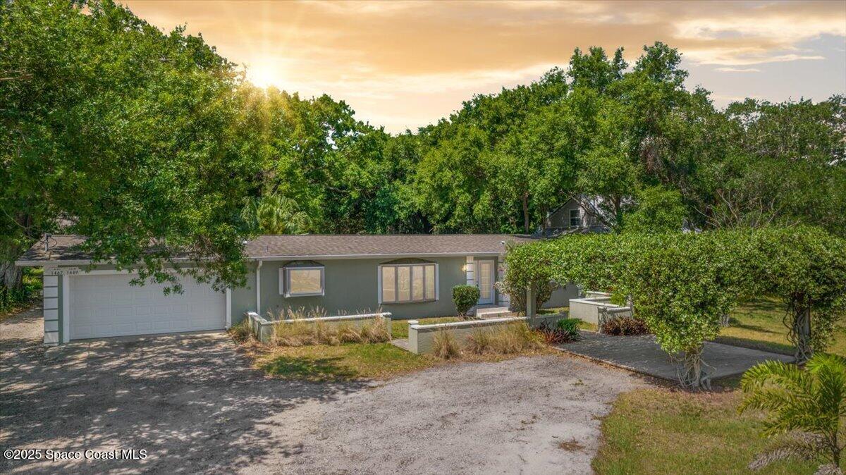 1469 Rockledge Drive Rockledge, FL 32955 - Photo 3 of 67 a front view of a house with a yard and garage
