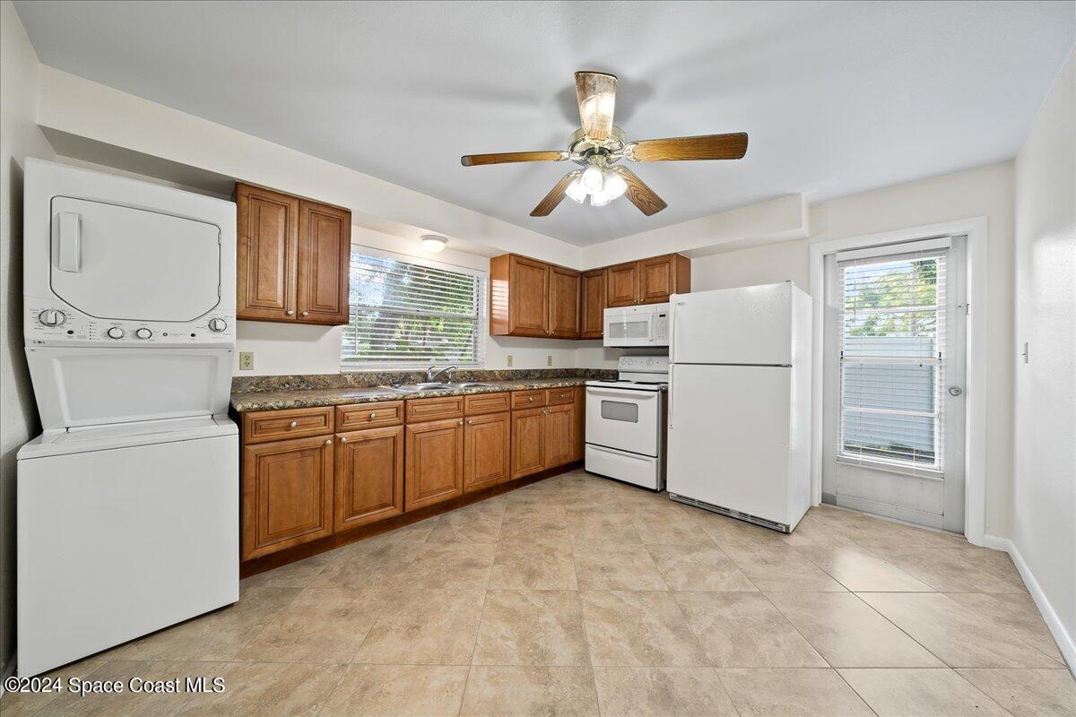 1469 Rockledge Drive Rockledge, FL 32955 - Photo 39 of 67 a kitchen with refrigerator cabinets and window