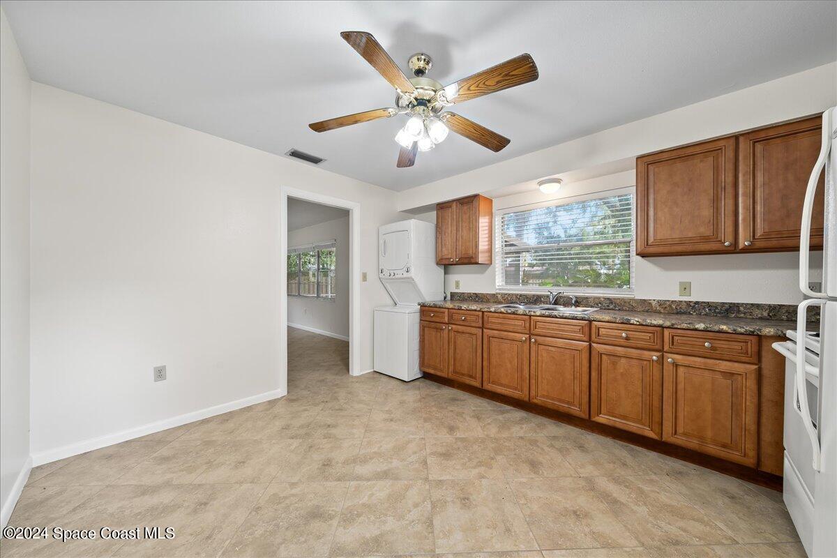 1469 Rockledge Drive Rockledge, FL 32955 - Photo 40 of 67 a kitchen with granite countertop a sink cabinets and window