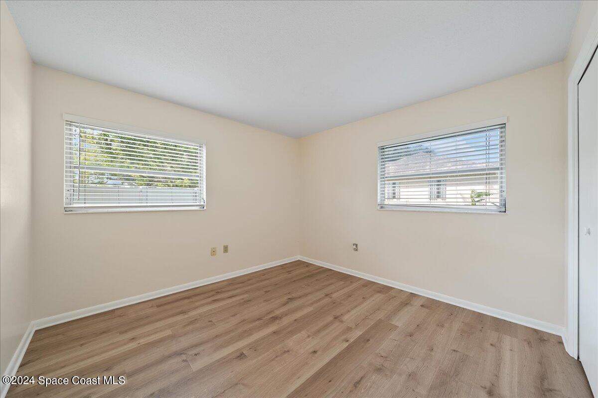 1469 Rockledge Drive Rockledge, FL 32955 - Photo 42 of 67 a view of an empty room with wooden floor and a window