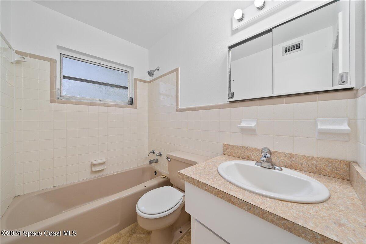 1469 Rockledge Drive Rockledge, FL 32955 - Photo 43 of 67 a bathroom with a sink and a toilet