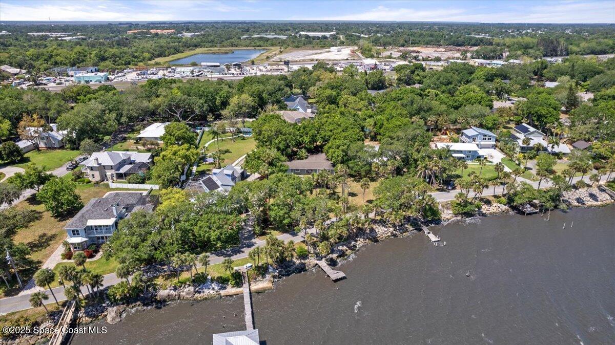 1469 Rockledge Drive Rockledge, FL 32955 - Photo 52 of 67 an aerial view of a city with lots of residential buildings and mountain view in back