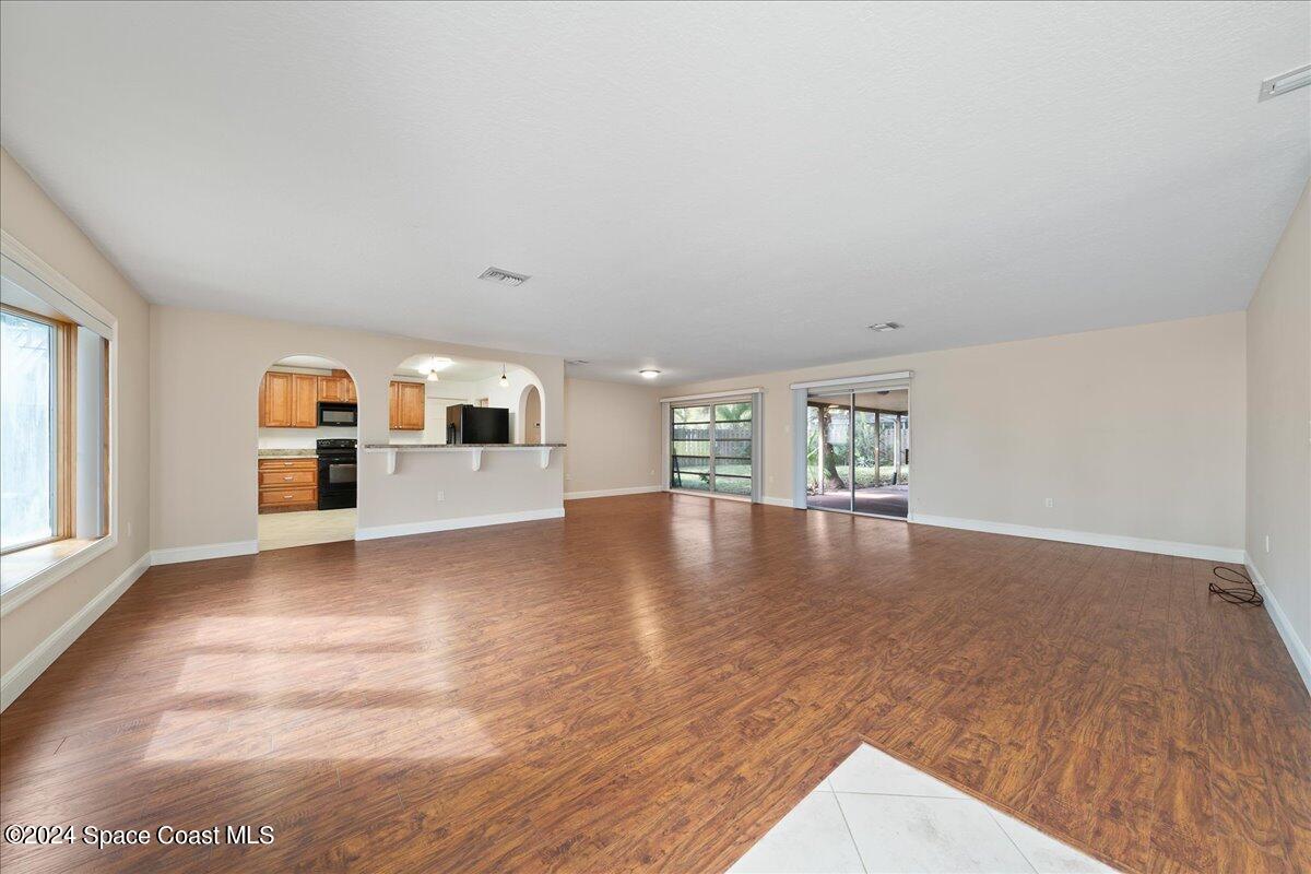 1469 Rockledge Drive Rockledge, FL 32955 - Photo 6 of 67 a view of empty room with wooden floor and fireplace
