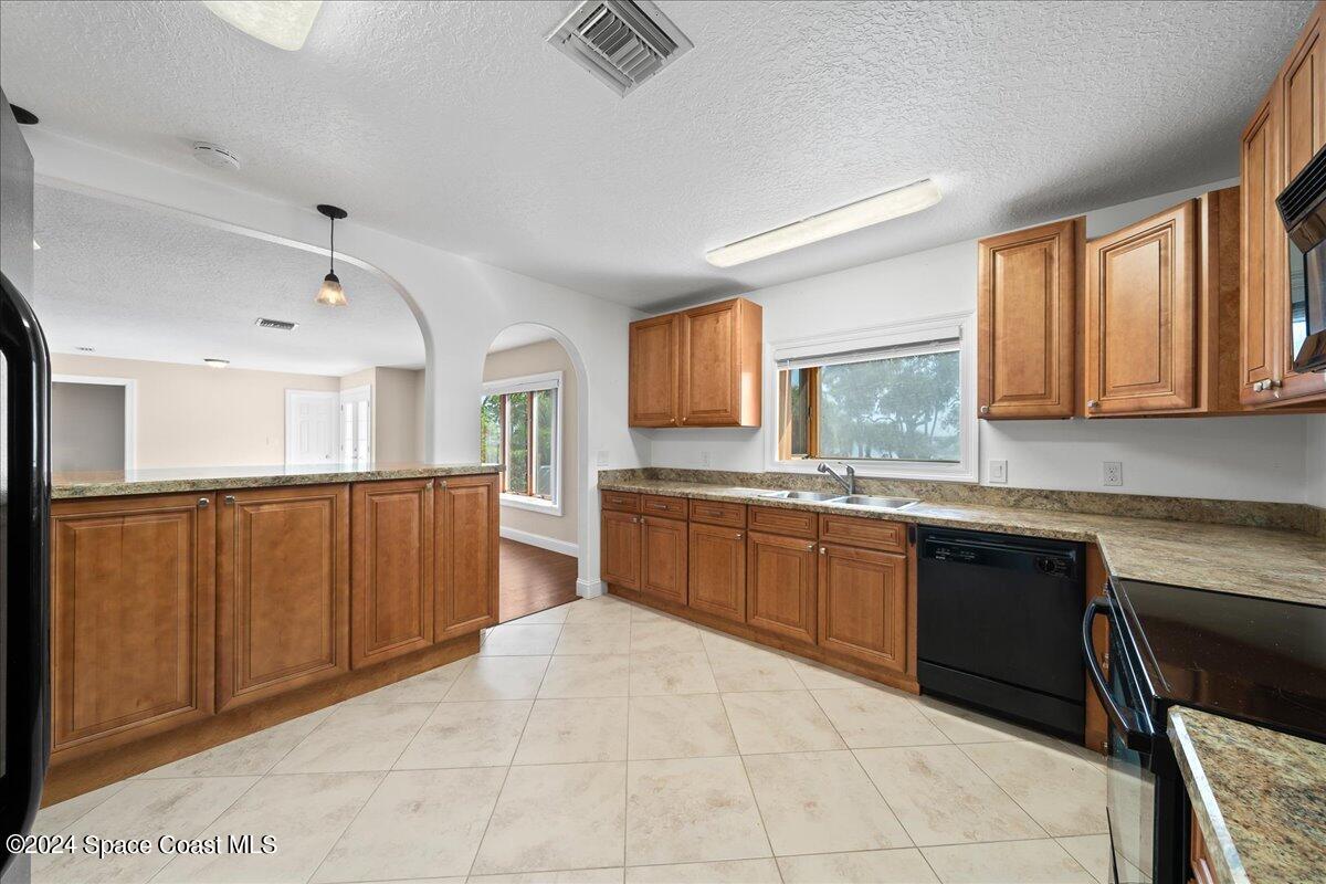 1469 Rockledge Drive Rockledge, FL 32955 - Photo 10 of 67 a large kitchen with stainless steel appliances granite countertop a sink counter space cabinets and a large window