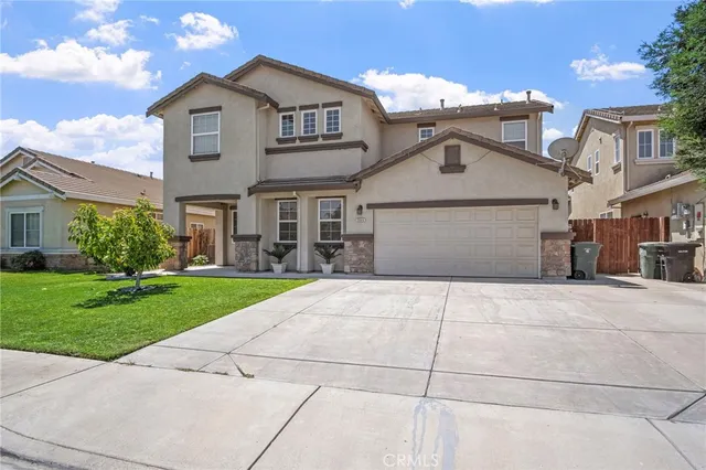 a view of a white house with a yard and plants
