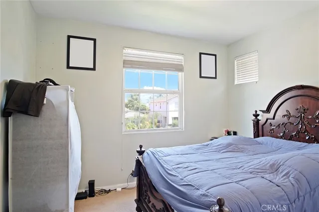 a bathroom with a toilet a sink a mirror a window and vanity