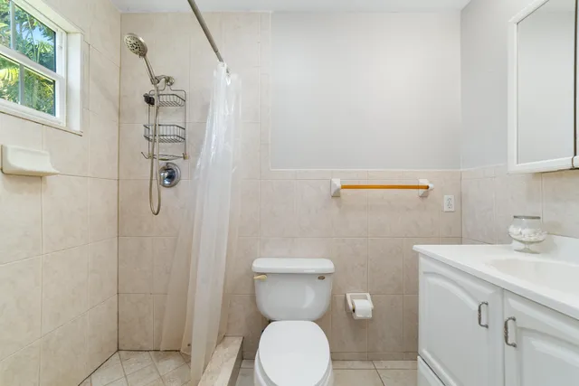 a bathroom with a toilet sink and shower