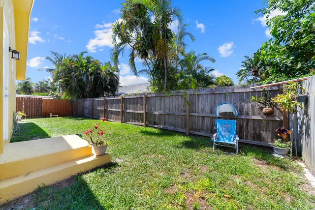 a view of a backyard with a garden and deck