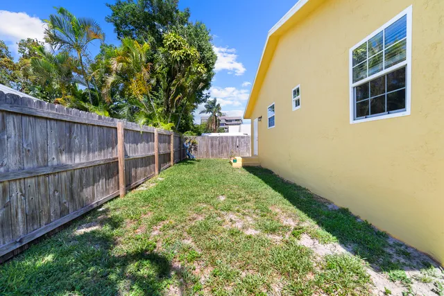 a view of a backyard with wooden fence