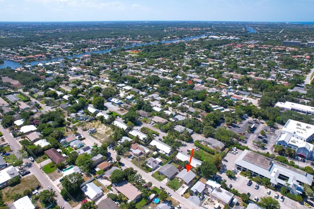 an aerial view of residential houses with city view