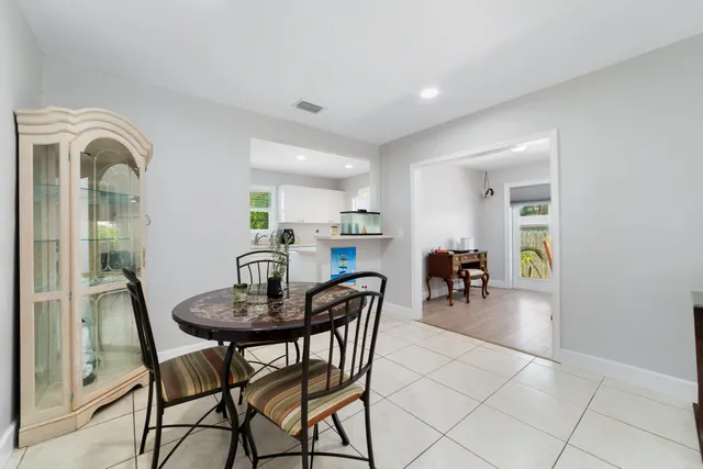 a view of a dining room with furniture and a potted plant