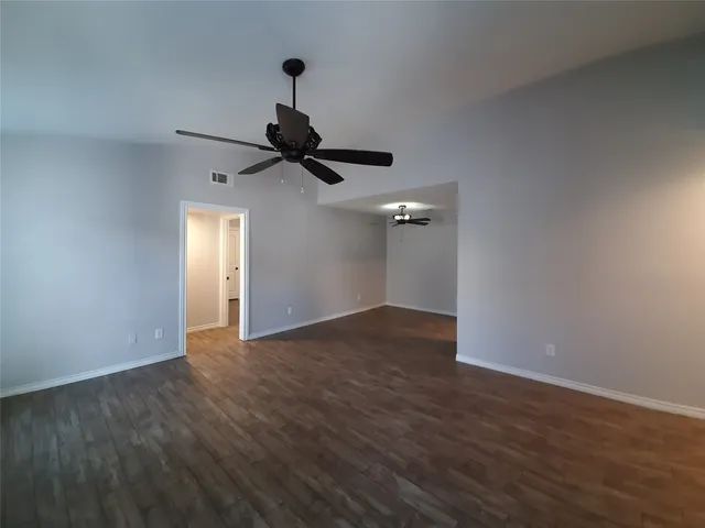 a view of an empty room and wooden floor
