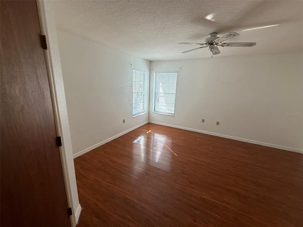 26186 Northern Cross Road, Unit 1B Punta Gorda, FL 33983 - Photo 12 of 22 wooden floor in an empty room