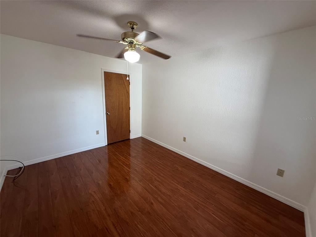 26186 Northern Cross Road, Unit 1B Punta Gorda, FL 33983 - Photo 16 of 22 wooden floor in an empty room