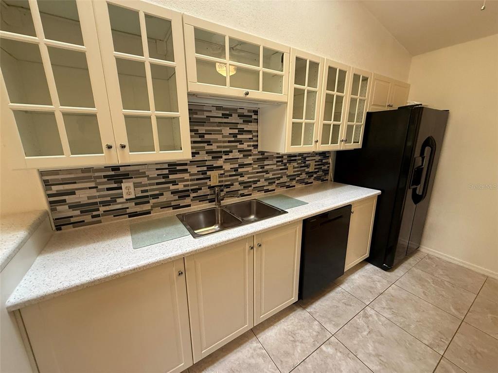 26186 Northern Cross Road, Unit 1B Punta Gorda, FL 33983 - Photo 8 of 22 a kitchen with a refrigerator and a sink