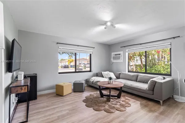 a living room with furniture and a flat screen tv