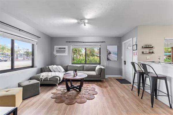 a living room with furniture and a large window