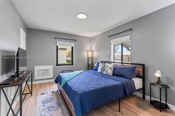 a bedroom with a bed and a flat screen tv