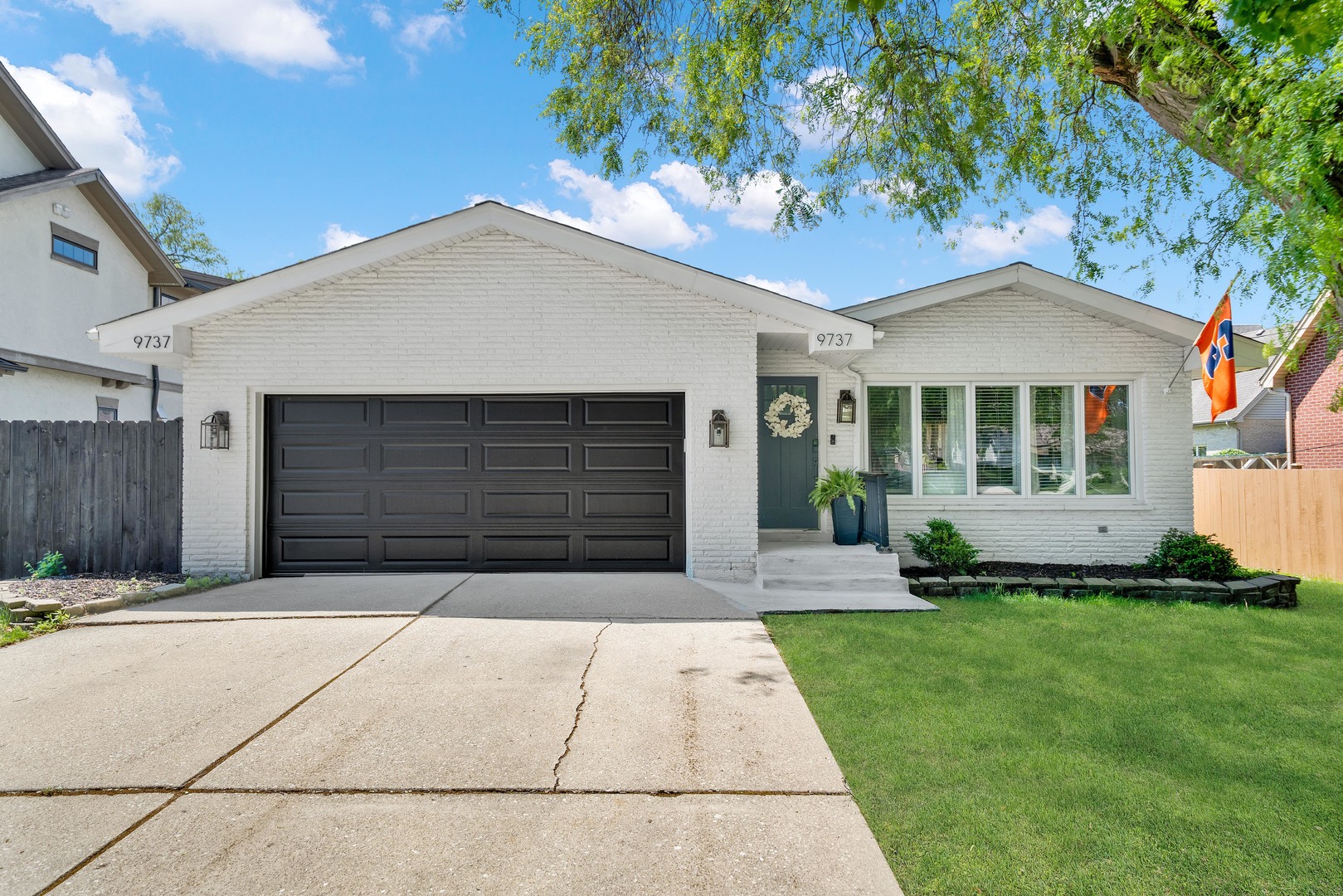 9737 West 57th Street Countryside, IL 60525 - Photo 1 of 19 a front view of a house with a yard