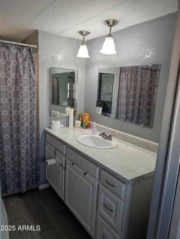 a bathroom with a toilet a sink and a mirror